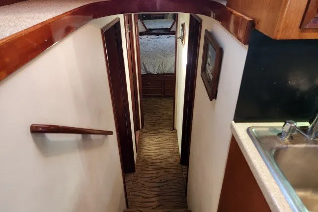 Slide: The Image of Interior hallway of 1987 Ocean Yachts 48 Super Sport, featuring wood accents and carpeted stairs. - 20