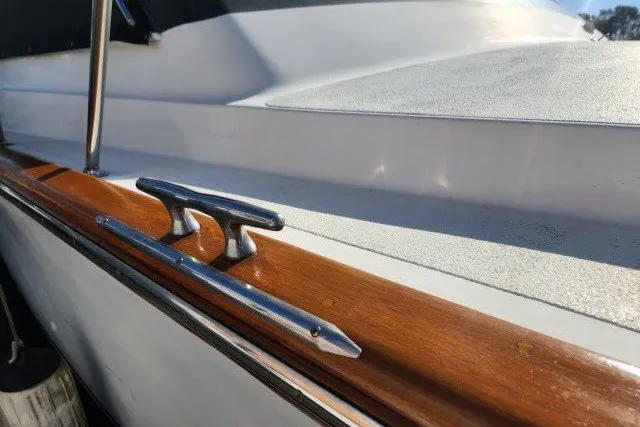 Slide: The Image of 1987 Ocean Yachts 48 Super Sport boat deck with polished wood and metal cleat. - 61