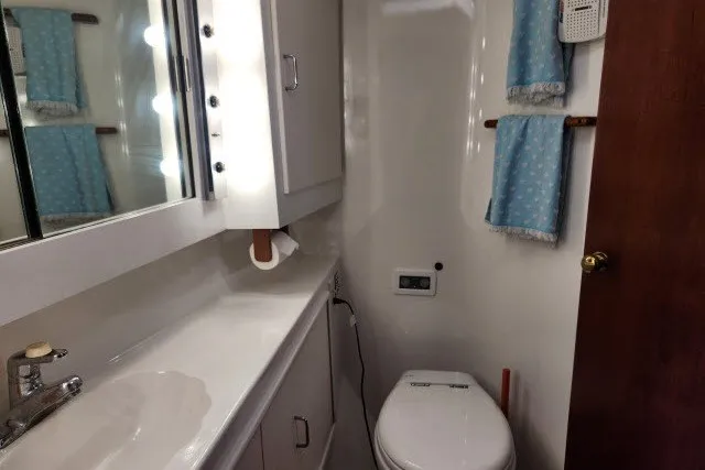 Slide: The Image of Bathroom interior of 1987 Ocean Yachts 48 Super Sport, featuring sink and toilet. - 29