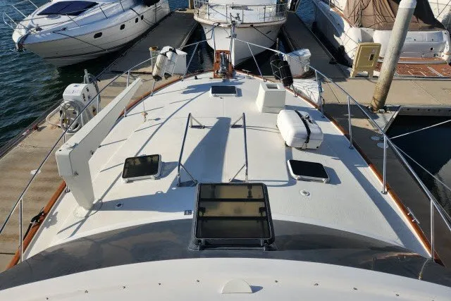 Slide: The Image of 1987 Ocean Yachts 48 Super Sport docked, showcasing spacious deck and sleek design. - 50
