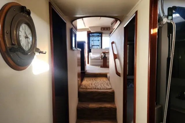 Slide: The Image of Interior hallway of 1987 Ocean Yachts 48 Super Sport, featuring nautical decor and wooden accents. - 33