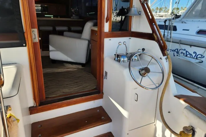 Slide: The Image of 1987 Ocean Yachts 48 Super Sport yacht helm with wooden accents and interior view. - 43