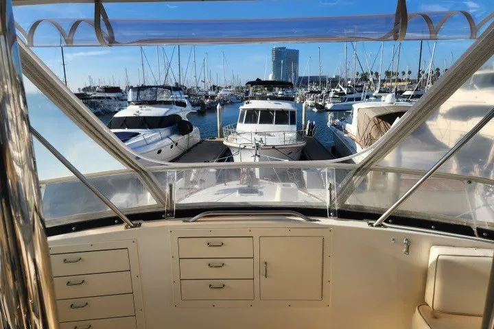 Slide: The Image of Cockpit view of 1987 Ocean Yachts 48 Super Sport in a marina with docked boats. - 49