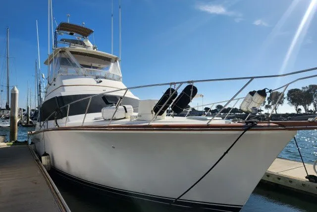 Slide: The Image of 1987 Ocean Yachts 48 Super Sport docked at marina under clear blue sky. - 59