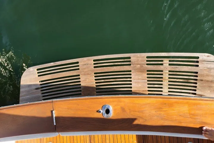 Slide: The Image of 1987 Ocean Yachts 48 Super Sport swim platform with teak wood finish over water. - 63