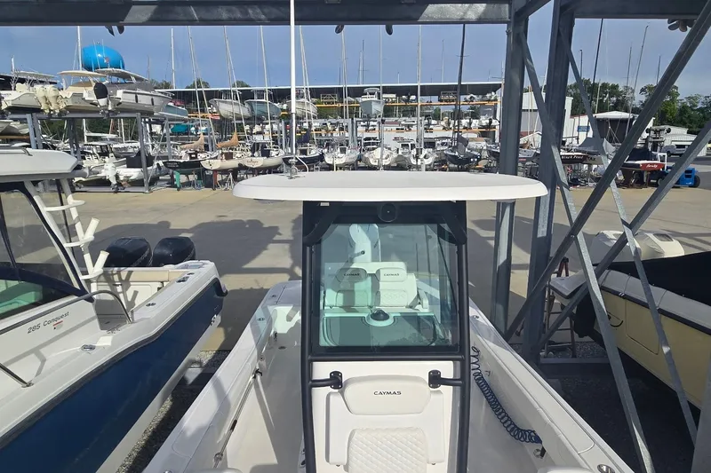 Slide: The Image of 2024 Caymas 281 HB boat in a marina, surrounded by various other boats. - 29