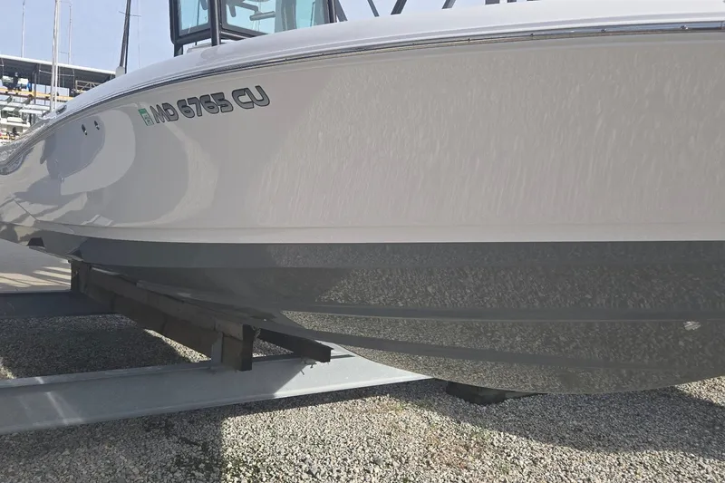 Slide: The Image of 2024 Caymas 281 HB boat on trailer, side view, displaying registration number. - 6