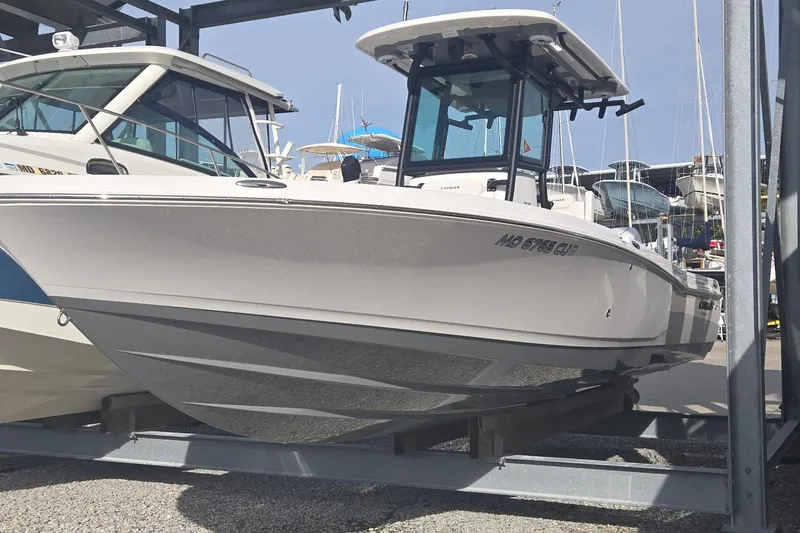 Slide: The Image of 2024 Caymas 281 HB boat displayed on a rack in a marina setting. - 4