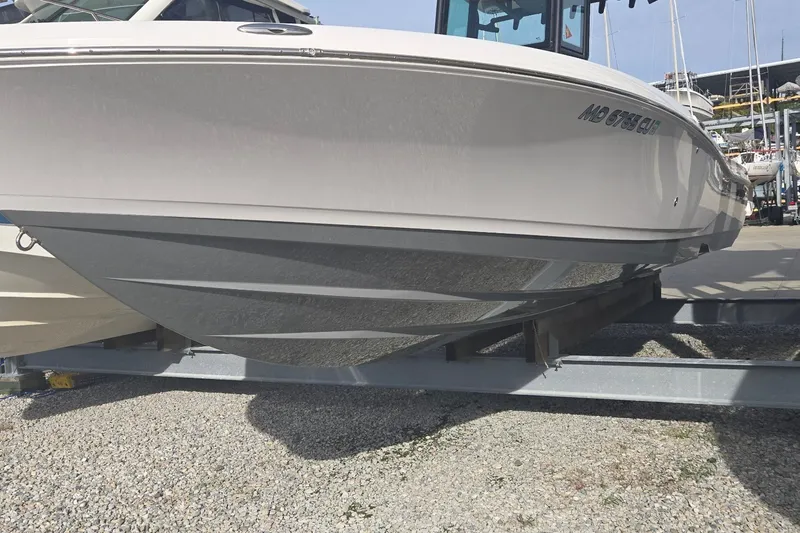 Slide: The Image of 2024 Caymas 281 HB boat on trailer, showcasing sleek hull design. - 7