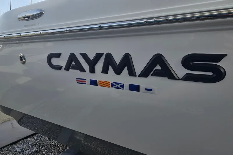 Slide: The Image of 2024 Caymas 281 HB boat with nautical flags on the side. - 36