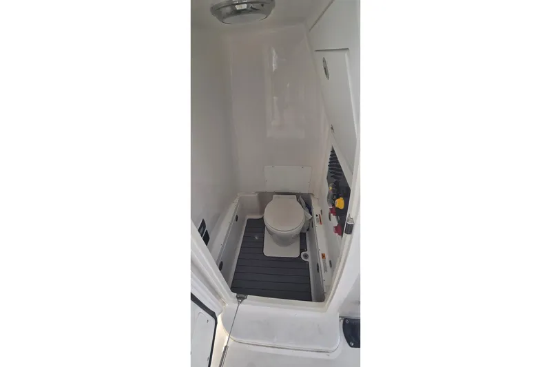 Slide: The Image of 2024 Caymas 281 HB boat interior with compact marine toilet. - 35