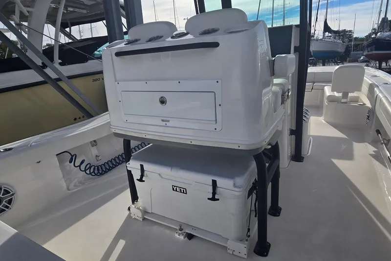 Slide: The Image of 2024 Caymas 281 HB boat interior with seating and Yeti cooler on deck. - 22