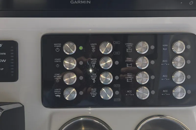 Slide: The Image of Control panel of 2024 Caymas 281 HB boat with various switches and indicators. - 25