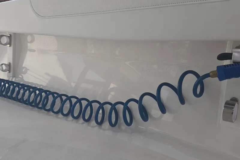 Slide: The Image of Blue coiled hose on 2024 Caymas 281 HB boat deck. - 34