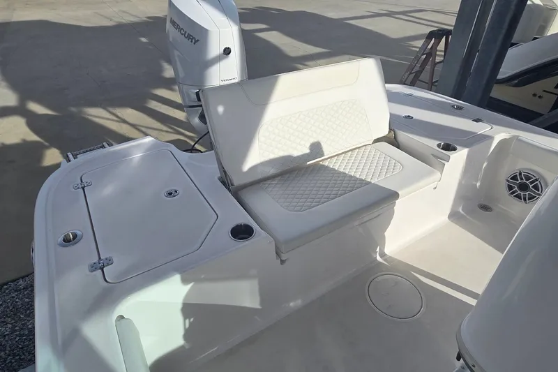 Slide: The Image of 2024 Caymas 281 HB boat interior with cushioned seating and Mercury engine. - 27