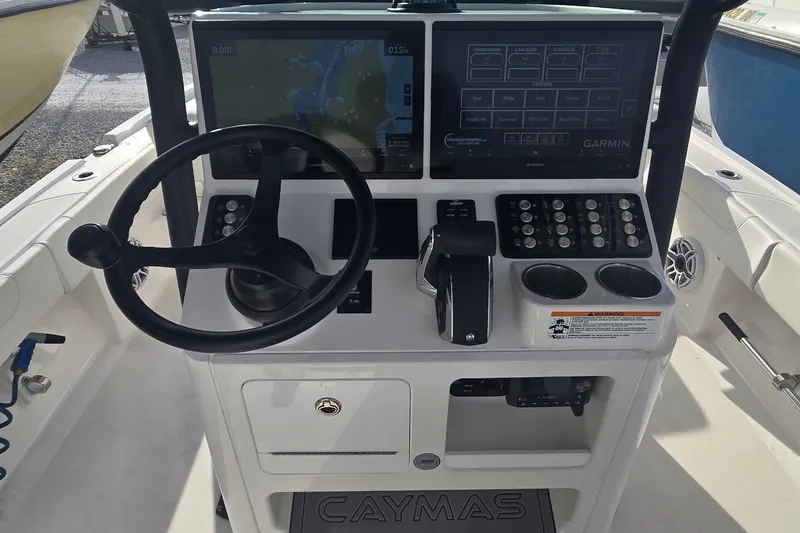 Slide: The Image of 2024 Caymas 281 HB boat dashboard with Garmin navigation and control panel. - 16