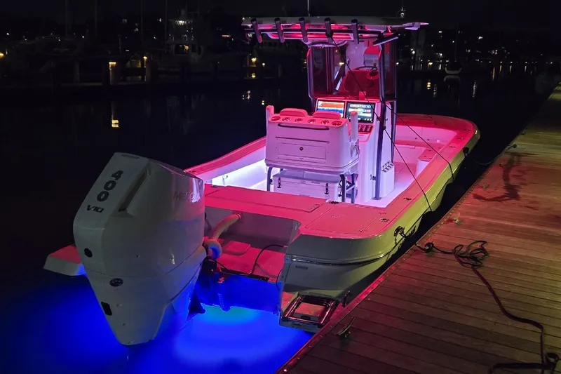 Slide: The Image of 2024 Caymas 281 HB boat illuminated at night with vibrant LED lights. - 42