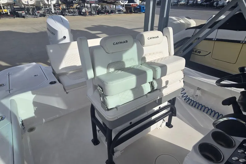 Slide: The Image of 2024 Caymas 281 HB boat interior with cushioned seating and steering console. - 21