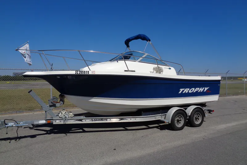 The Image of 2007 Bayliner 2052 Trophy Walkaround DX/LX boat on trailer, parked outdoors. - 1