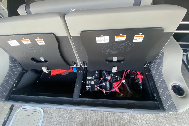 Slide: The Image of 2023 Barletta Lusso 25UCA boat seat storage with visible wiring and components. - 19
