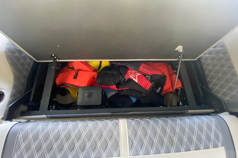 Slide: The Image of Storage compartment in 2023 Barletta Lusso 25UCA with life jackets and gear. - 21