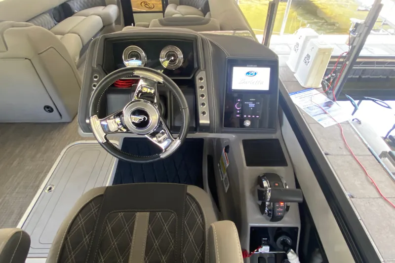 Slide: The Image of 2023 Barletta Lusso 25UCA boat dashboard with steering wheel and control panel. - 13