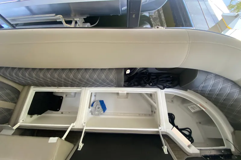 Slide: The Image of 2023 Barletta Lusso 25UCA boat interior storage compartments with seating and ropes. - 33