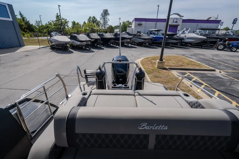 Slide: The Image of 2023 Barletta Lusso 25UCA pontoon boat in a dealership parking lot. - 17