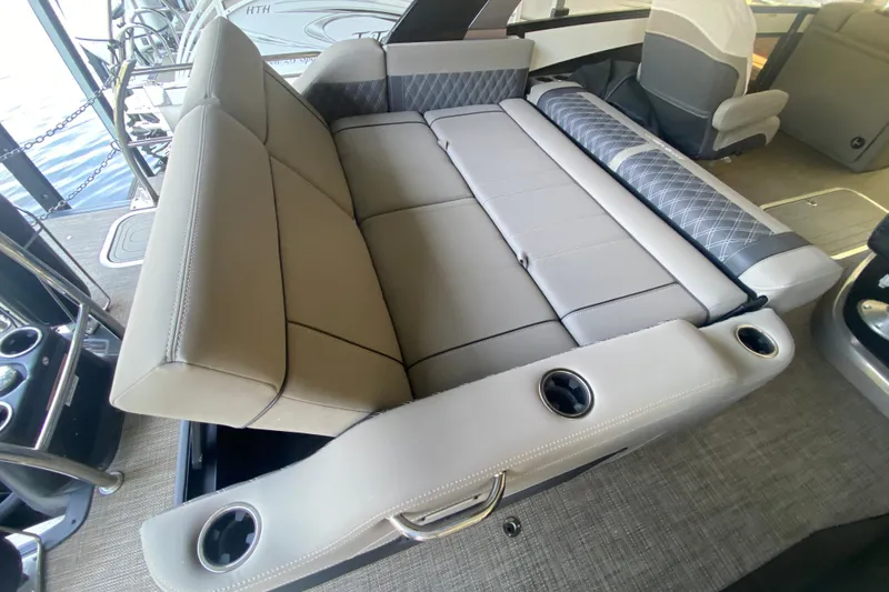 Slide: The Image of 2023 Barletta Lusso 25UCA boat interior with luxurious seating and cup holders. - 20