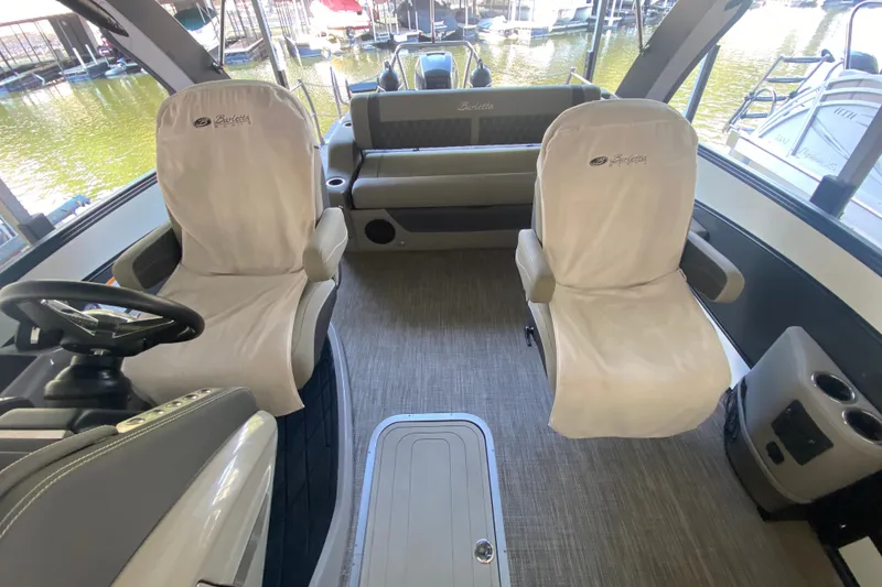 Slide: The Image of Interior of 2023 Barletta Lusso 25UCA boat with plush seating and modern design. - 28