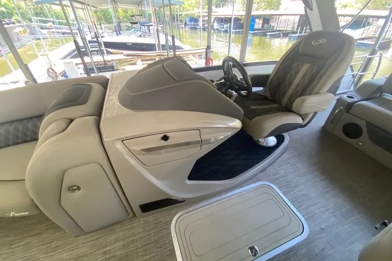 Slide: The Image of 2023 Barletta Lusso 25UCA boat interior with captain's chair and helm station. - 16