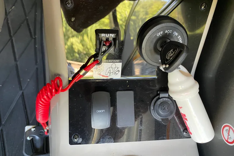 Slide: The Image of Control panel of 2023 Barletta Lusso 25UCA with ignition key and safety lanyard. - 25