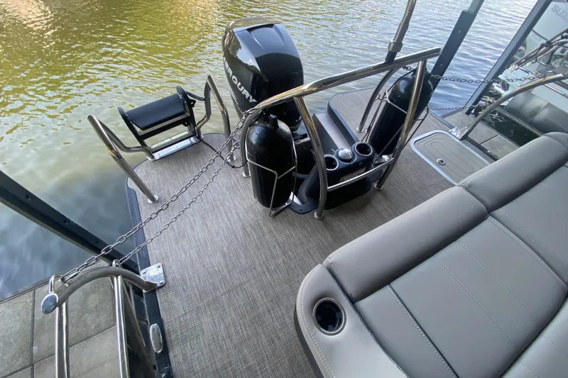 Slide: The Image of 2023 Barletta Lusso 25UCA pontoon boat with Mercury engine, rear seating, and swim platform. - 10