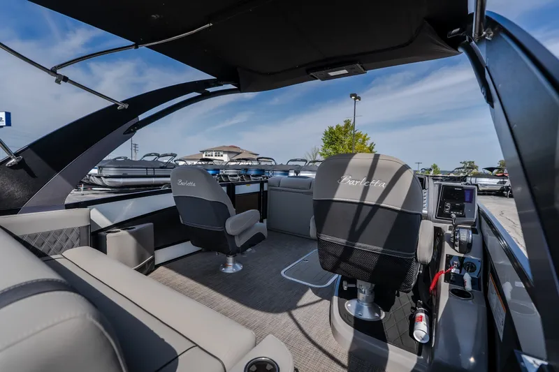 Slide: The Image of 2023 Barletta Lusso 25UCA pontoon boat interior with luxurious seating and modern controls. - 22