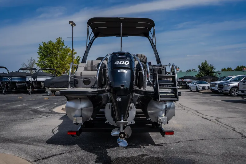 Slide: The Image of 2023 Barletta Lusso 25UCA pontoon boat with powerful engine, parked outdoors. - 15