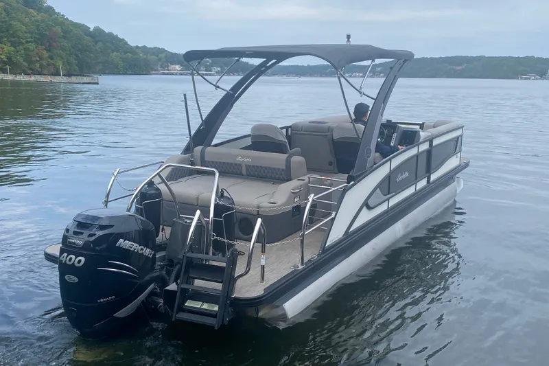 Slide: The Image of 2023 Barletta Lusso 25UCA pontoon boat on a serene lake with Mercury 400 engine. - 5