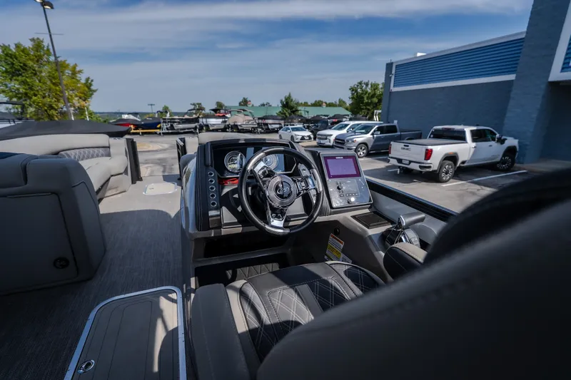 Slide: The Image of 2023 Barletta Lusso 25UCA boat interior with modern dashboard and steering wheel. - 24