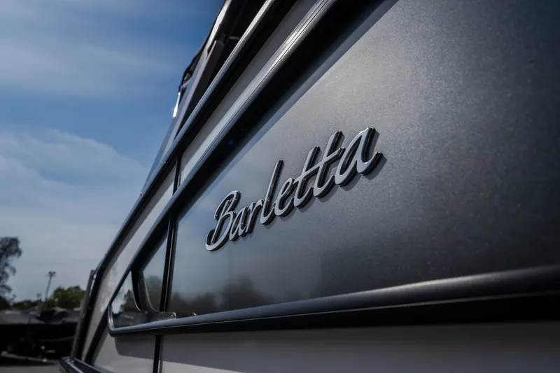 Slide: The Image of 2023 Barletta Lusso 25UCA boat with sleek design and logo detail. - 12