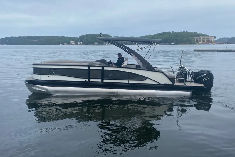 Slide: The Image of 2023 Barletta Lusso 25UCA pontoon boat cruising on a calm lake. - 7