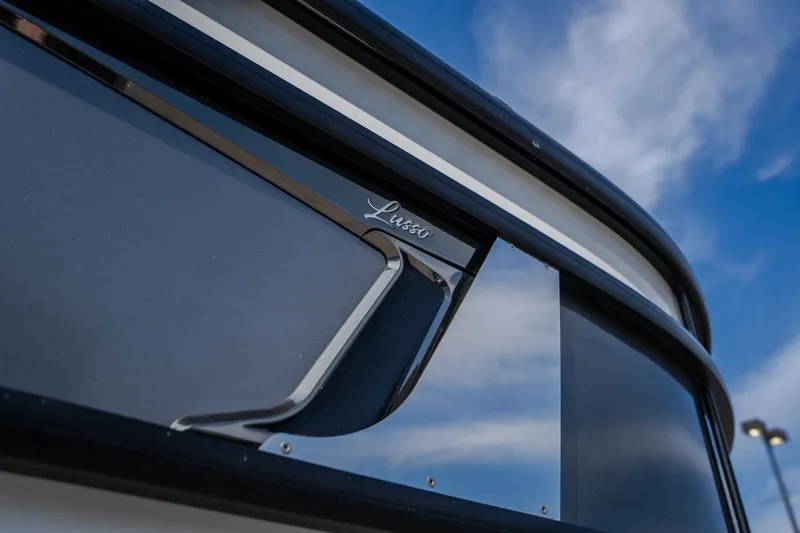 Slide: The Image of Close-up of 2023 Barletta Lusso 25UCA boat exterior against a blue sky. - 11