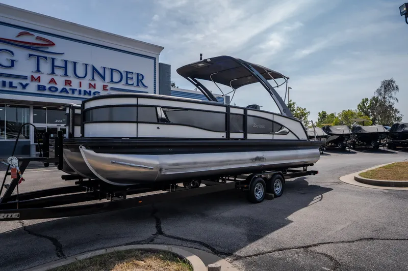 Slide: The Image of 2023 Barletta Lusso 25UCA pontoon boat on trailer at Big Thunder Marine dealership. - 7