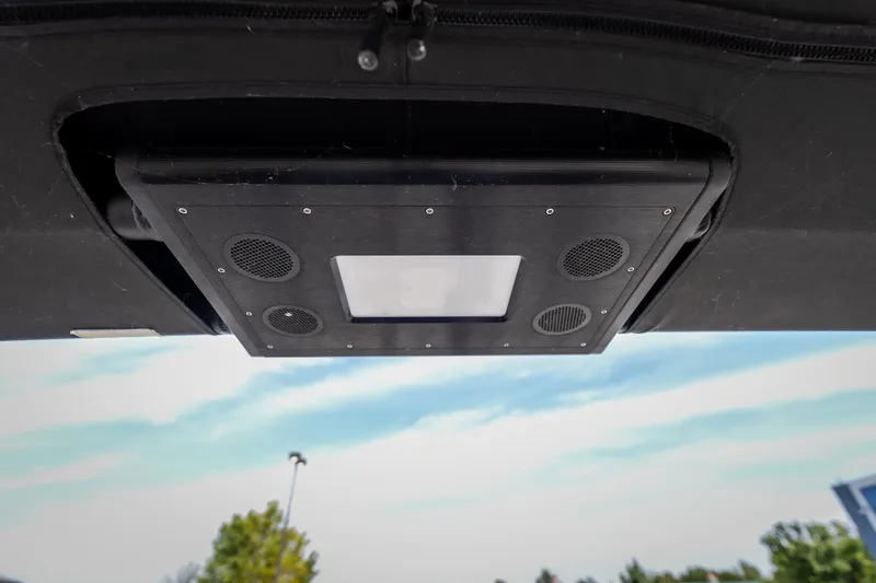 Slide: The Image of 2023 Barletta Lusso 25UCA boat speaker system under canopy, clear sky background. - 46