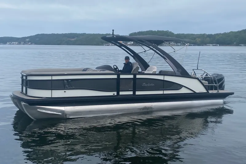 Slide: The Image of 2023 Barletta Lusso 25UCA pontoon boat on a calm lake. - 8