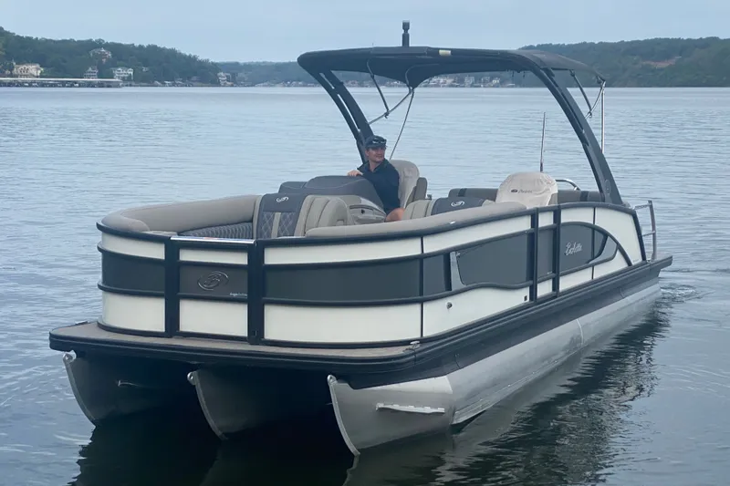 Slide: The Image of 2023 Barletta Lusso 25UCA pontoon boat cruising on a serene lake. - 9