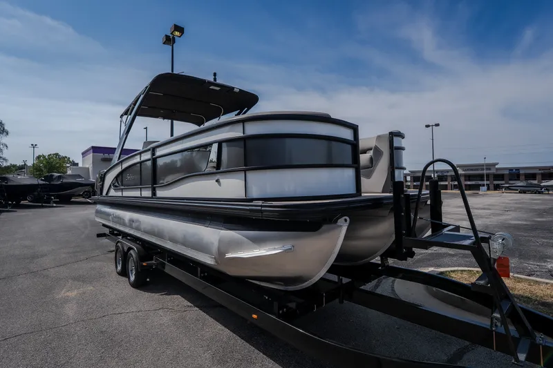 Slide: The Image of 2023 Barletta Lusso 25UCA pontoon boat on trailer in parking lot. - 10