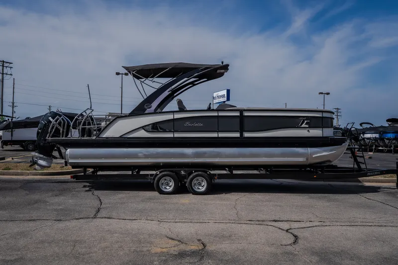 Slide: The Image of 2023 Barletta Lusso 25UCA pontoon boat on trailer under blue sky. - 5