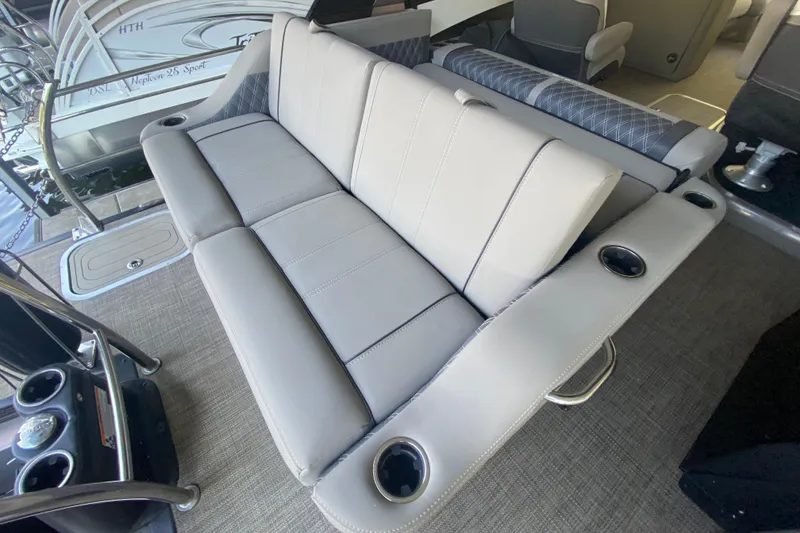 Slide: The Image of 2023 Barletta Lusso 25UCA boat interior with luxurious seating and cup holders. - 12