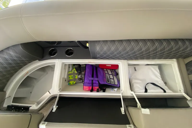 Slide: The Image of 2023 Barletta Lusso 25UCA storage compartments with life jackets and bags. - 32