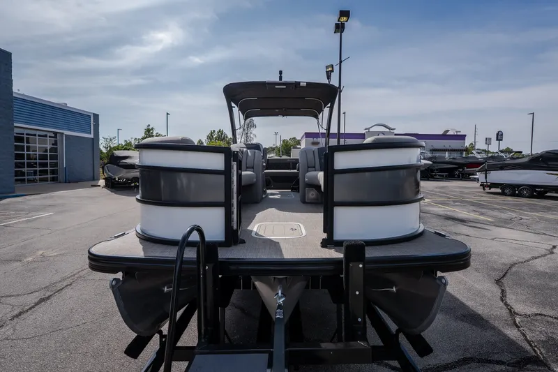 Slide: The Image of 2023 Barletta Lusso 25UCA pontoon boat in a dealership parking lot. - 8