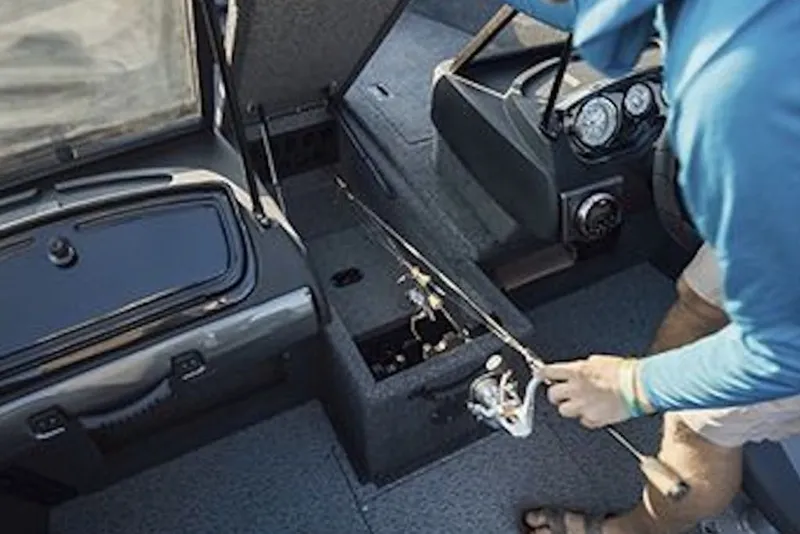 Slide: The Image of Person handling fishing rod on 2027 Crestliner 1750 Hawk WT boat interior. - 4
